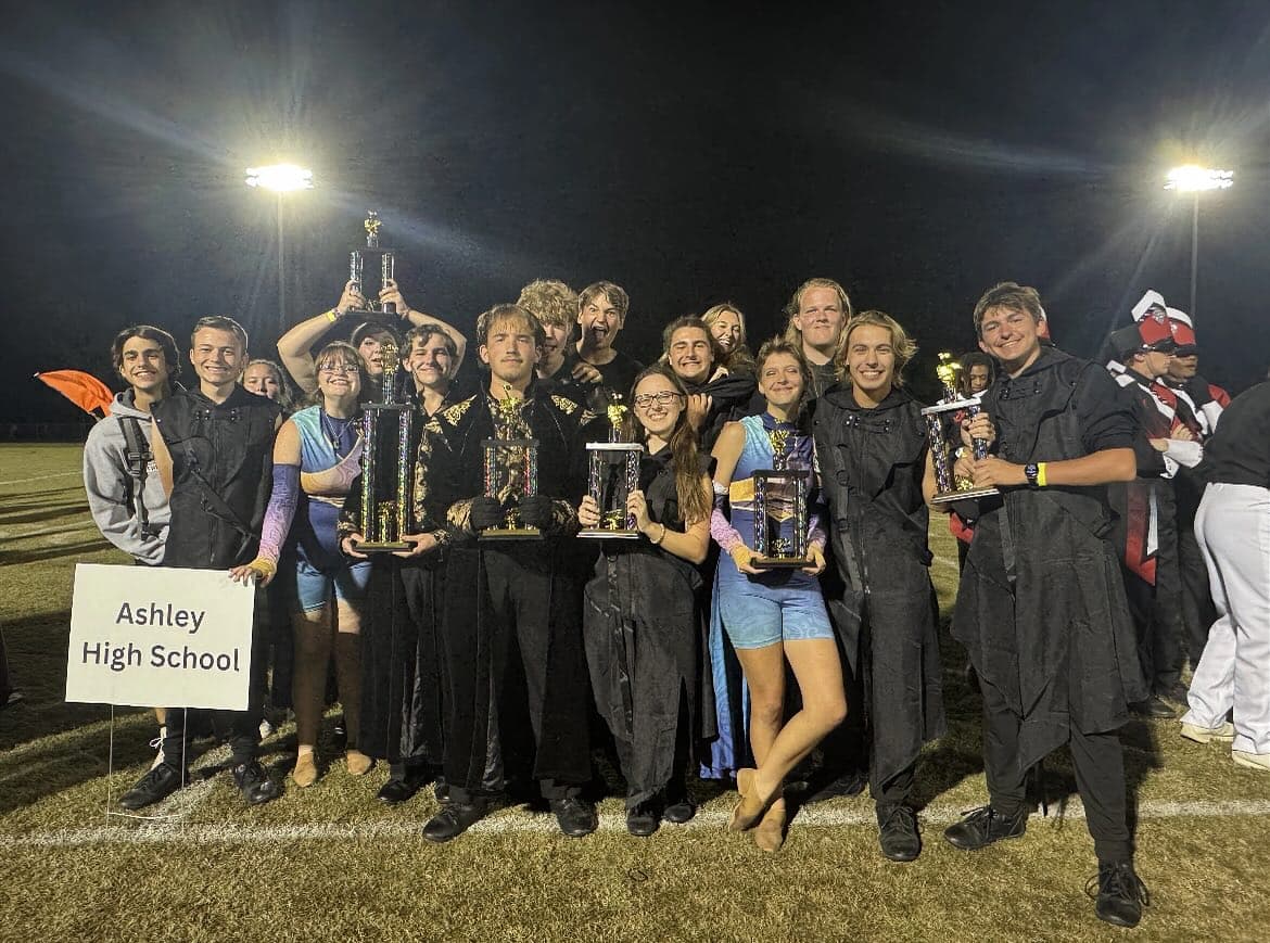 Ashley marching band students with trophies